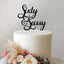 Sixty & Sassy Script 60th Birthday Cake Topper in Black Glitter