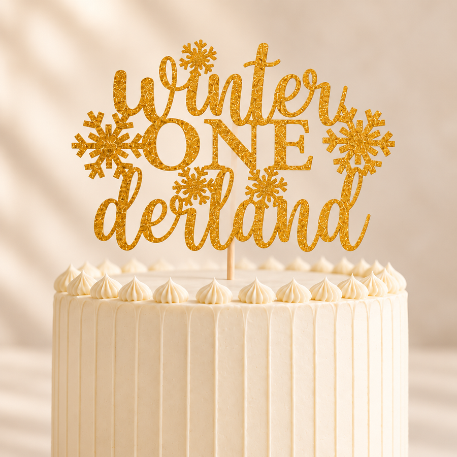 Close-up of a gold glitter Winter ONEderland cake topper on an ivory buttercream cake