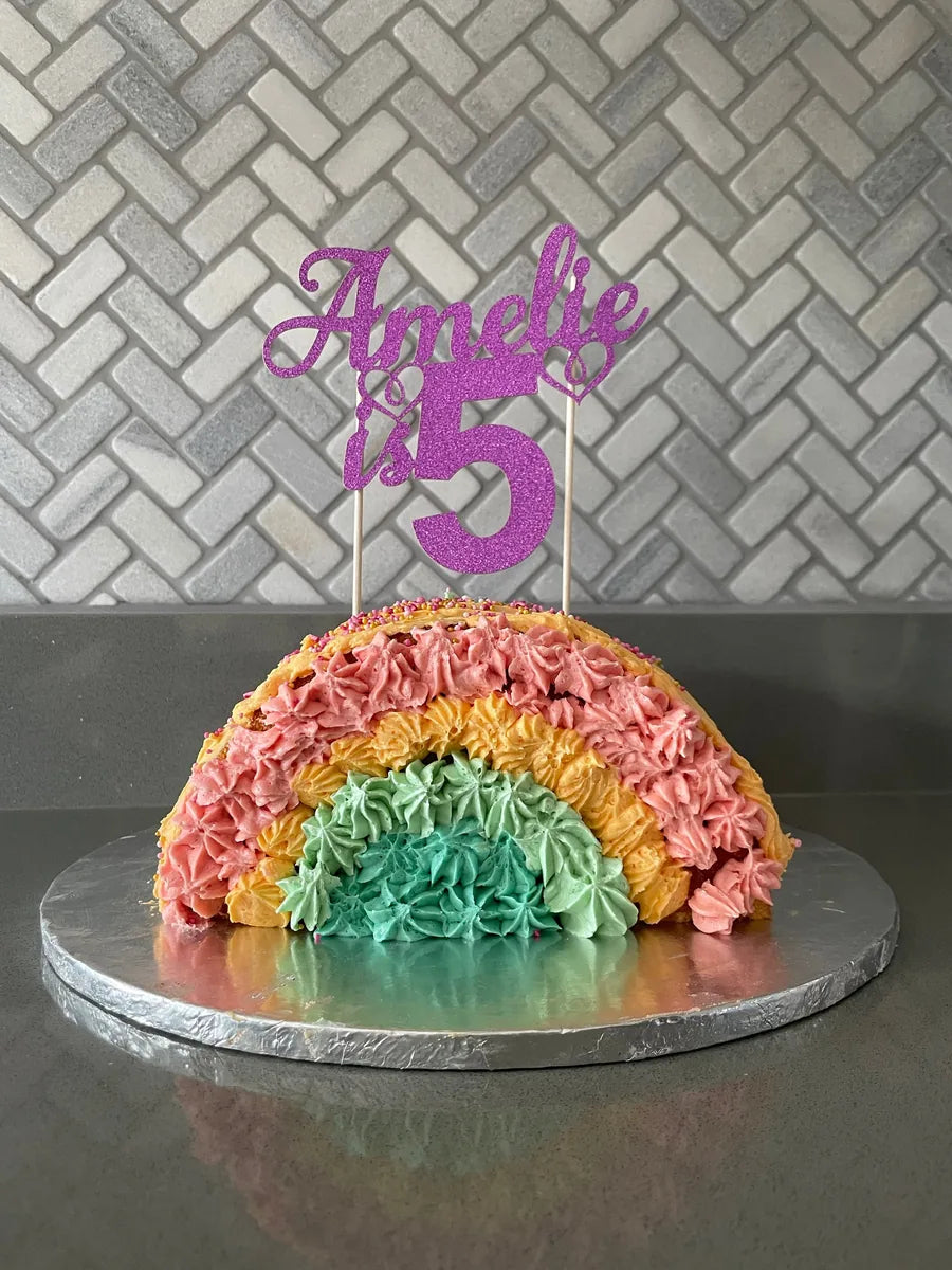 Purple glitter Amelie is 5 topper on a rainbow birthday cake