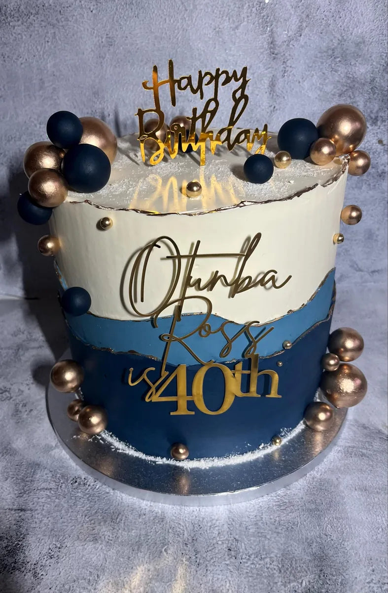 Gold Happy Birthday topper and personalised gold wording on a navy and cream 40th birthday cake
